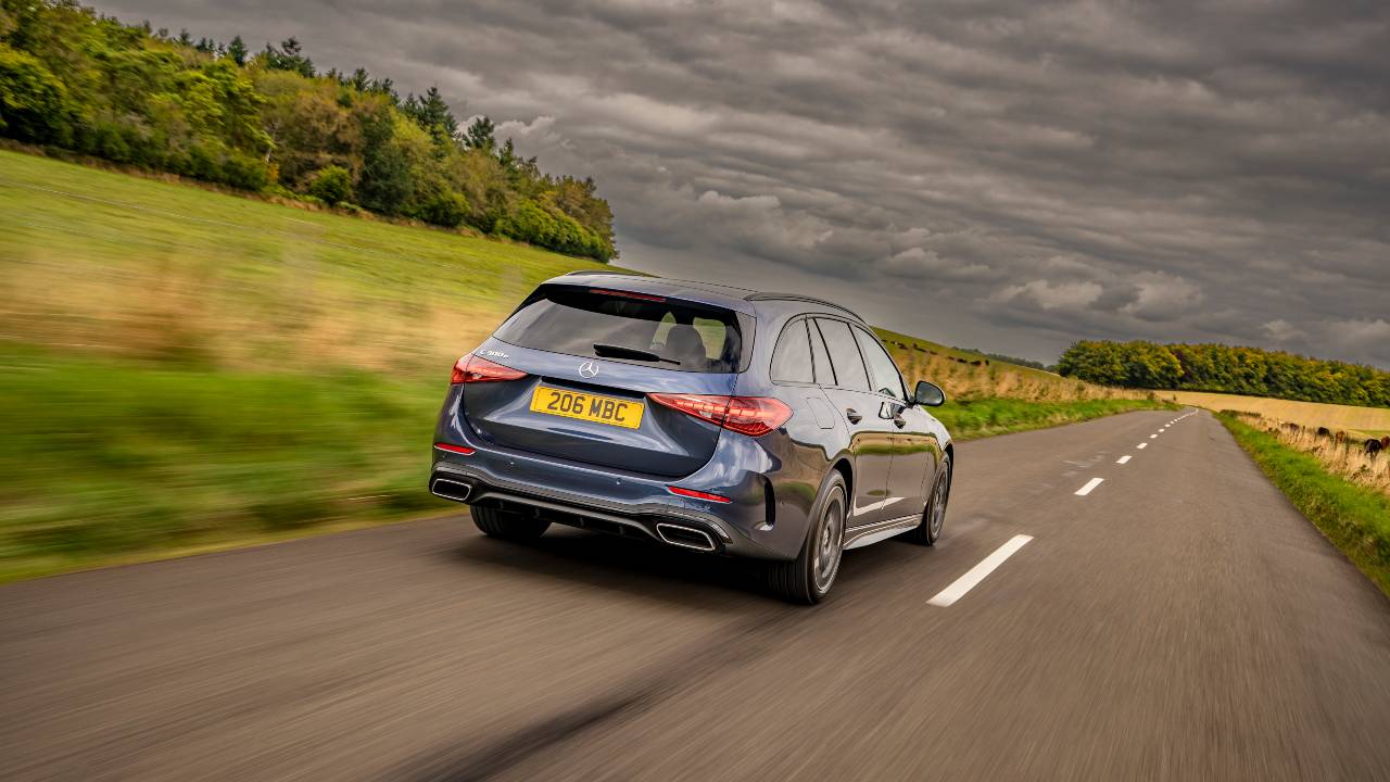 Mercedes-Benz C-Class Estate driving on country road, rear three-quarter view