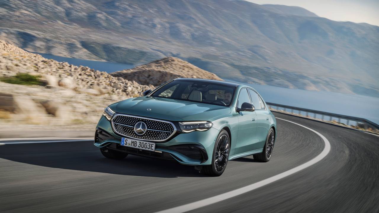 Mercedes-Benz E-Class saloon driving on winding coastal road, front view