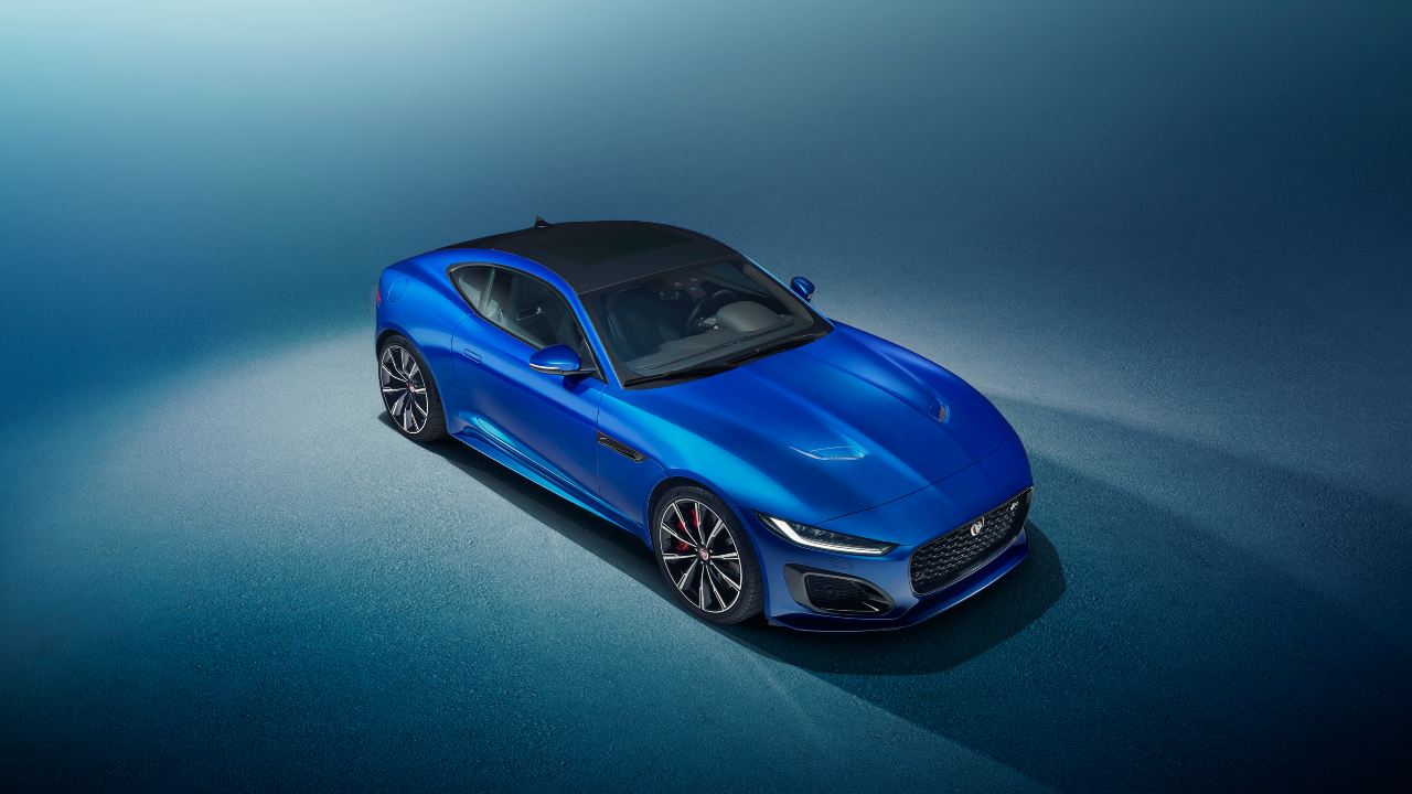 Blue Jaguar F-Type sports coupe shown in an elevated studio photography setting