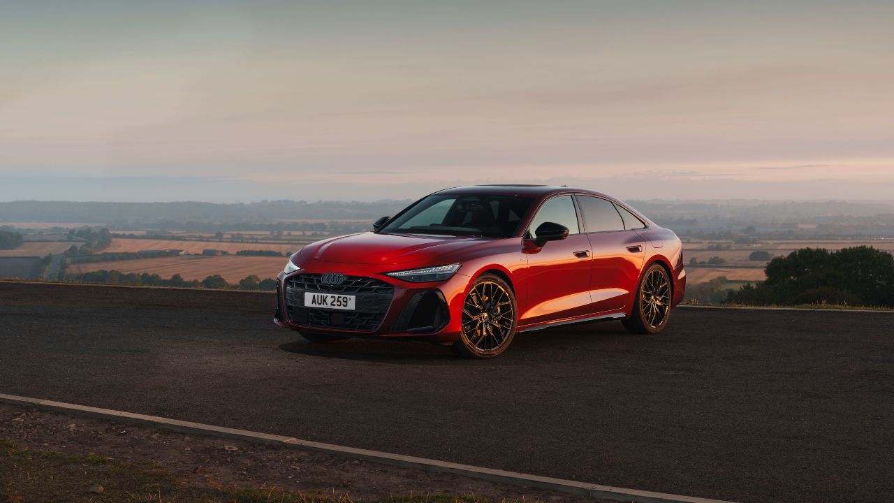 Red Audi A6 Saloon parked on a road at sunset