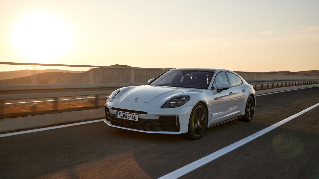 White Porsche Panamera driving on a motorway at sunset