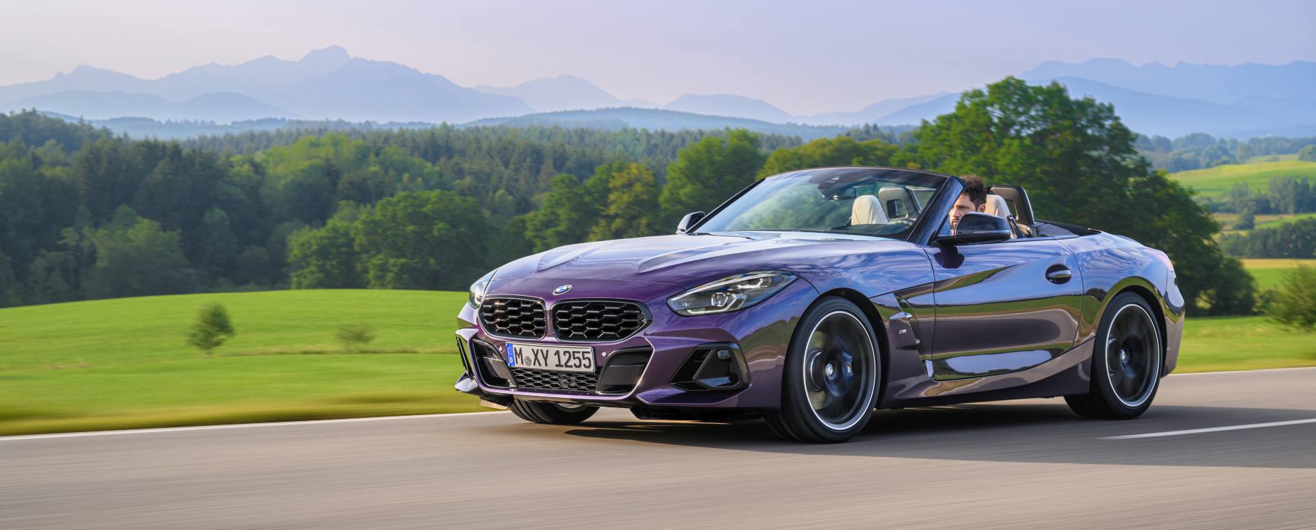 BMW Z4 purple driving with roof down