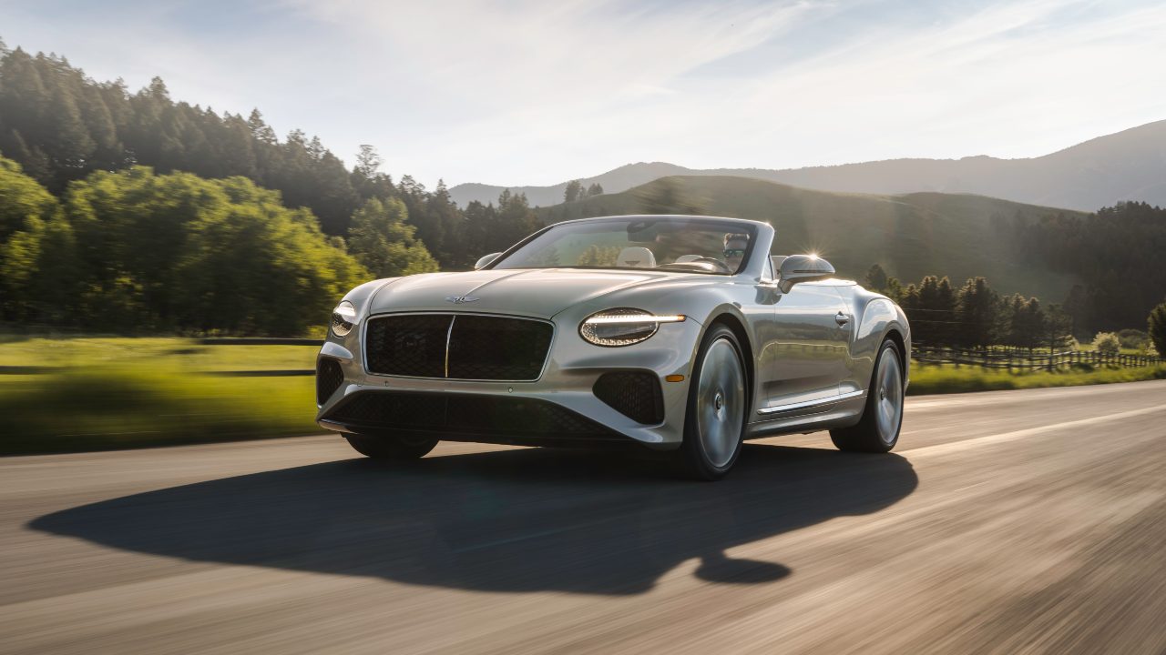Silver Bentley Continental GTC driving with roof down