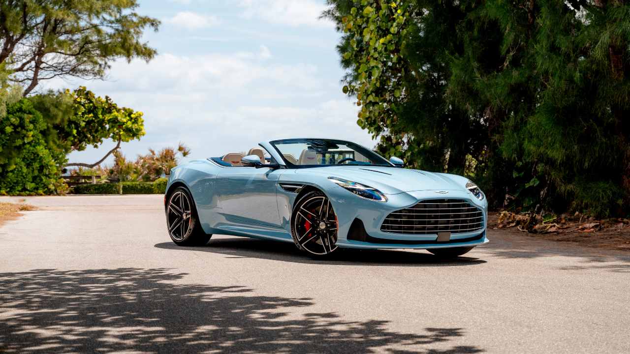 Blue Aston Martin DB12 Volante static with roof down