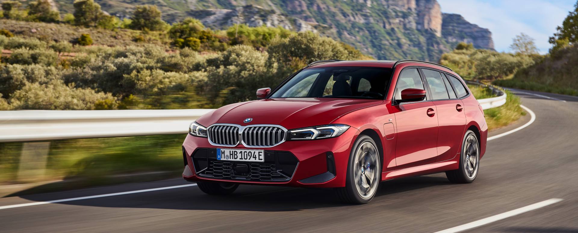 Red BMW 3 Series estate driving front right