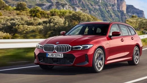 Red BMW 3 Series estate driving front right