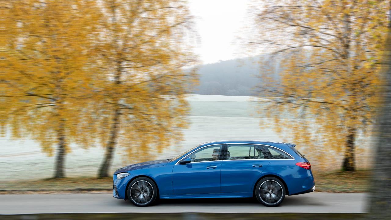 Blue Mercedes-Benz E-Class Estate side driving