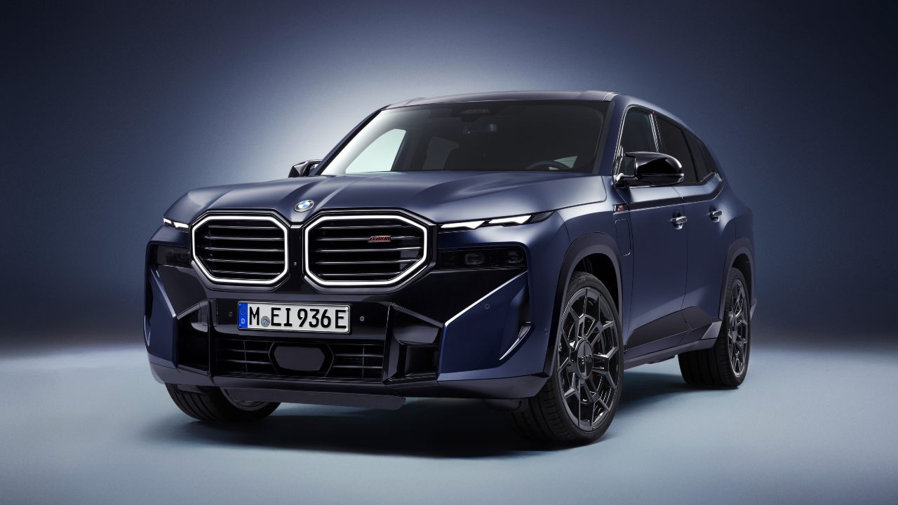 BMW XM SUV in blue studio setting, front three-quarter view