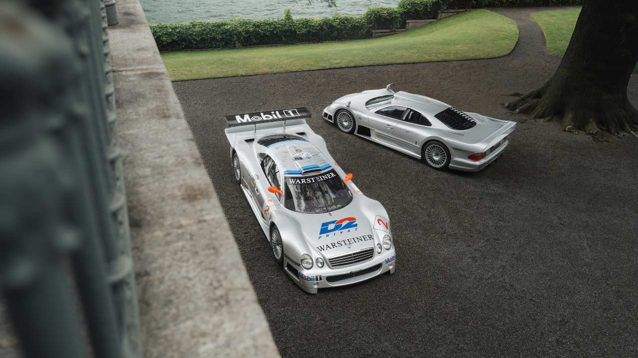 Mercedes-Benz CLK GTR race and road cars in silver parked on lakeside driveway, aerial view