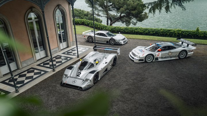 Mercedes-Benz CLK GTR, C11 race car and road car displayed outside lakeside villa