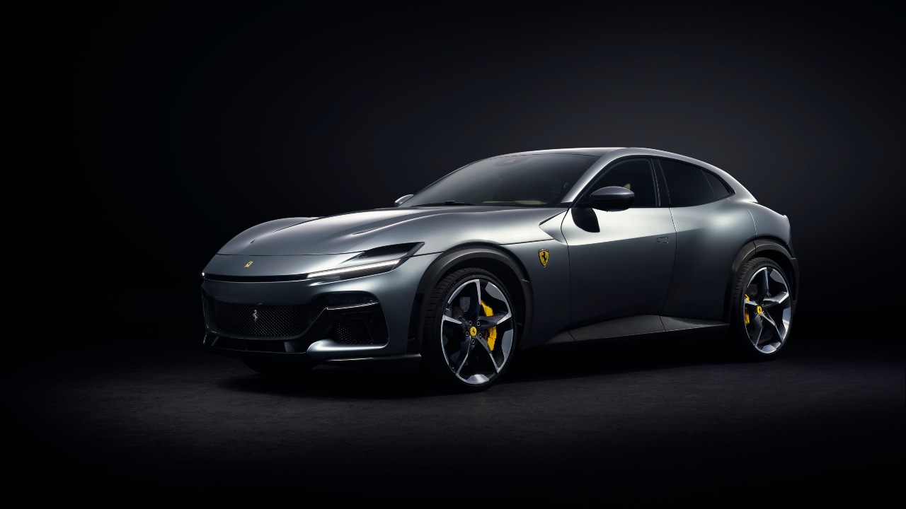 Ferrari Purosangue in dark studio lighting showcasing sleek performance SUV design