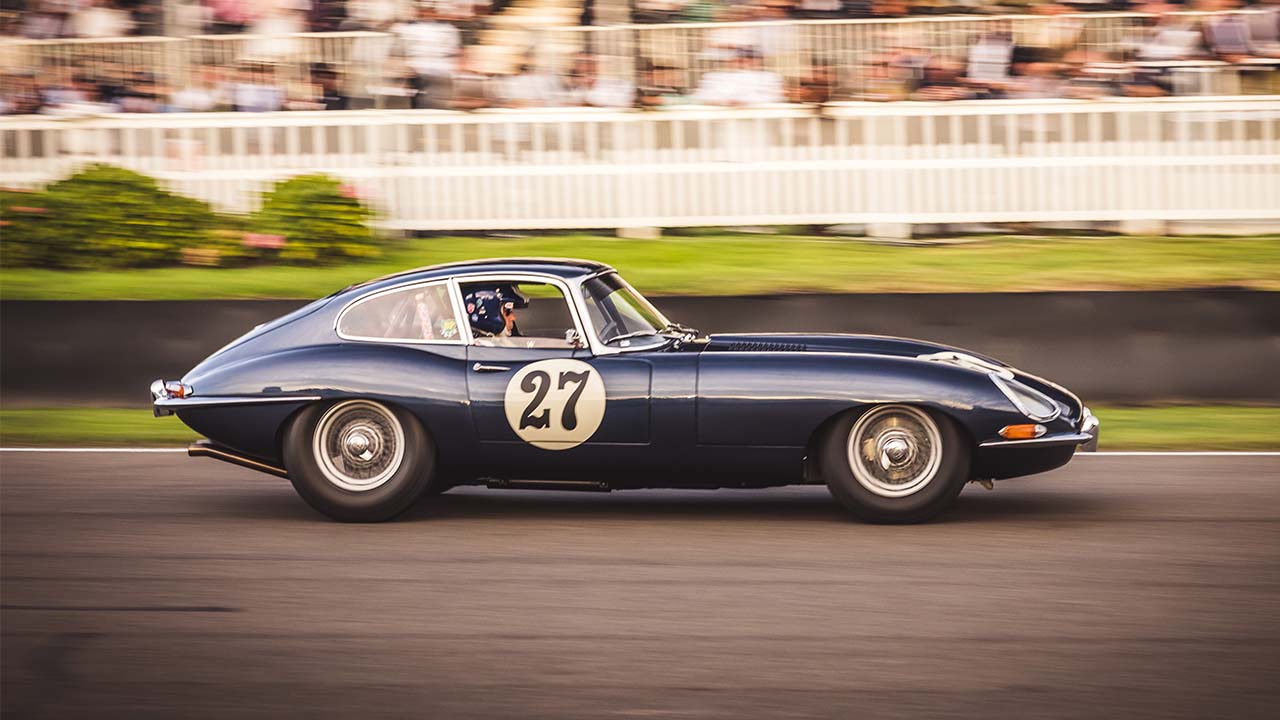 Blue Jaguar E-Type Exterior Side Driving on Race Track