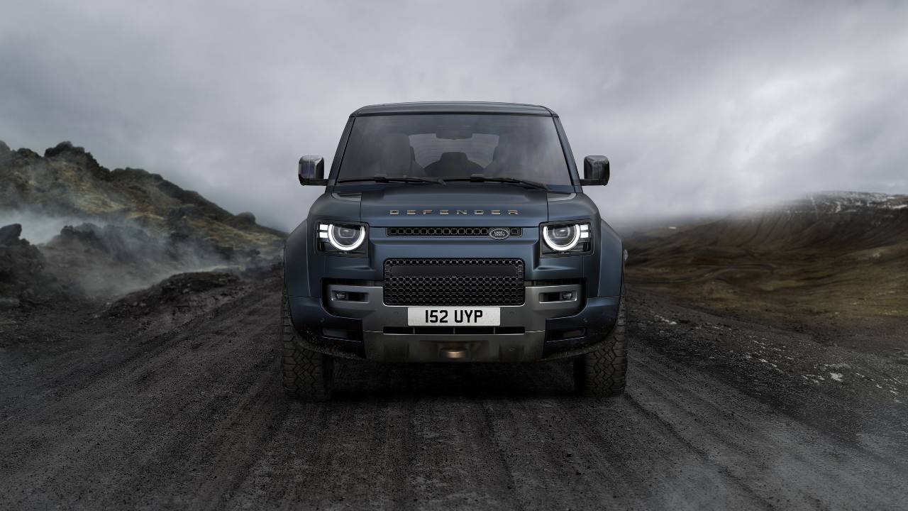 Land Rover Defender OCTA shown from the front on a rugged off‑road trail