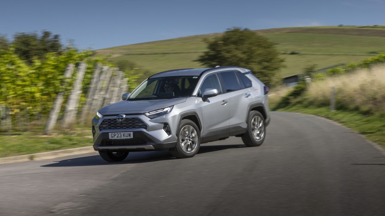 Toyota RAV4 SUV driving on a country road through green countryside