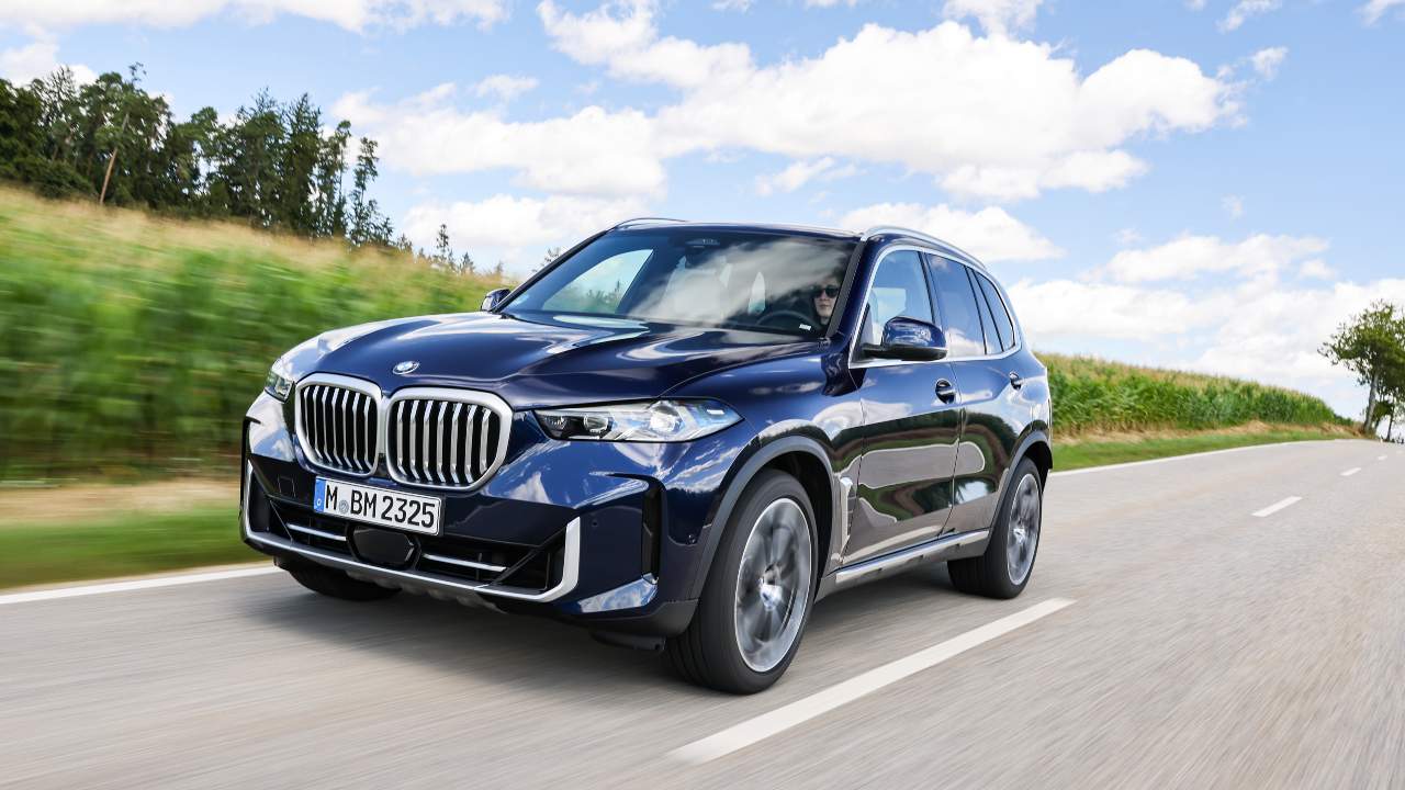 BMW X5 SUV driving on a country road from a front three‑quarter perspective