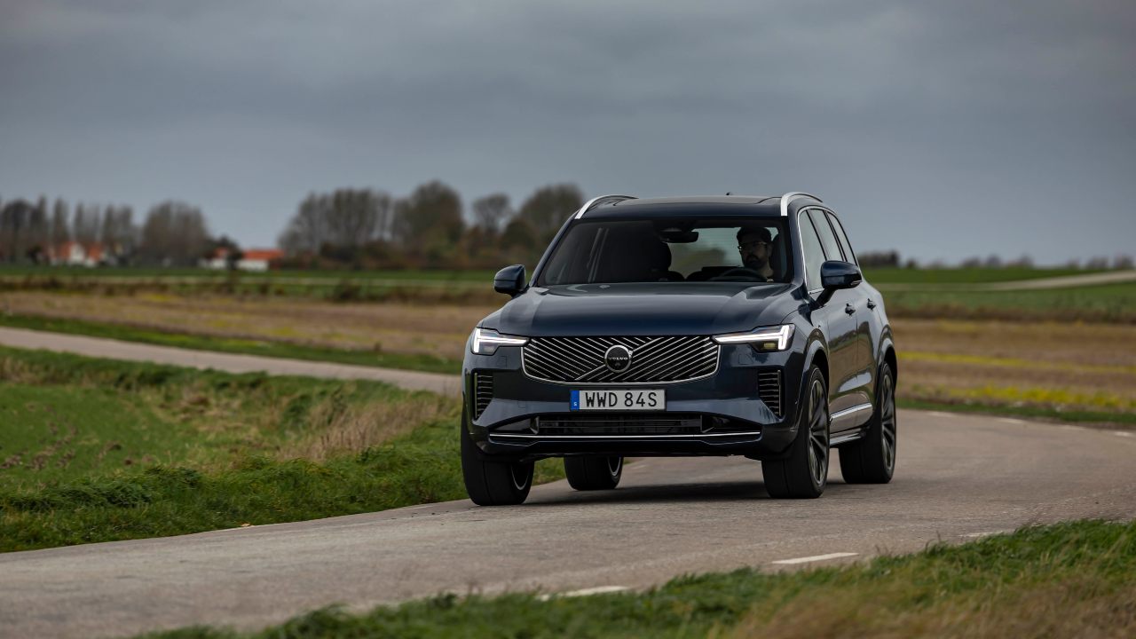 Volvo XC90 SUV driving on a rural road in open countryside