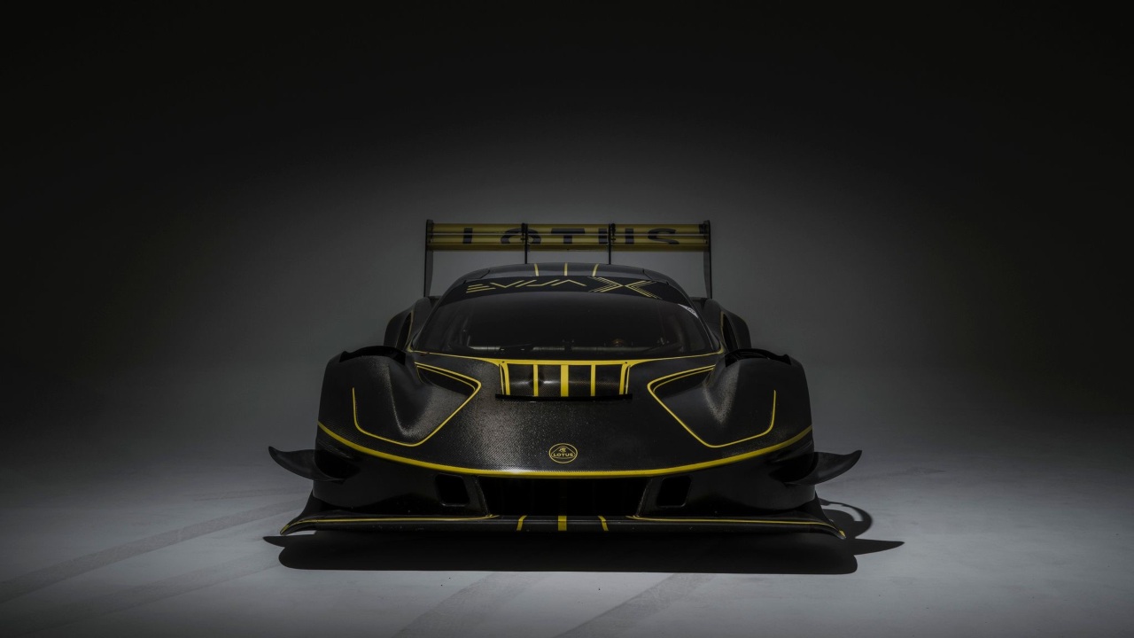 Lotus Evija X front-facing view showing aerodynamic nose, cooling vents and illuminated gold accents