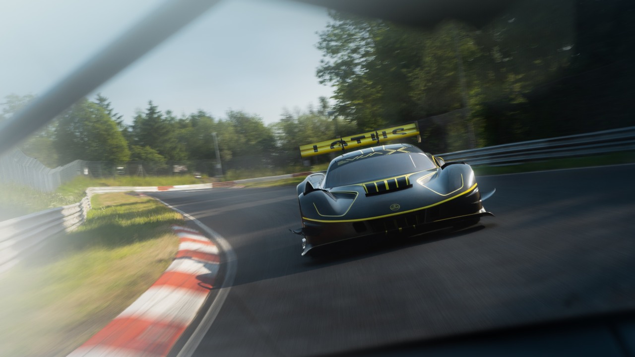Lotus Evija X electric hypercar driving at speed on racetrack with motion blur emphasising performance and handling