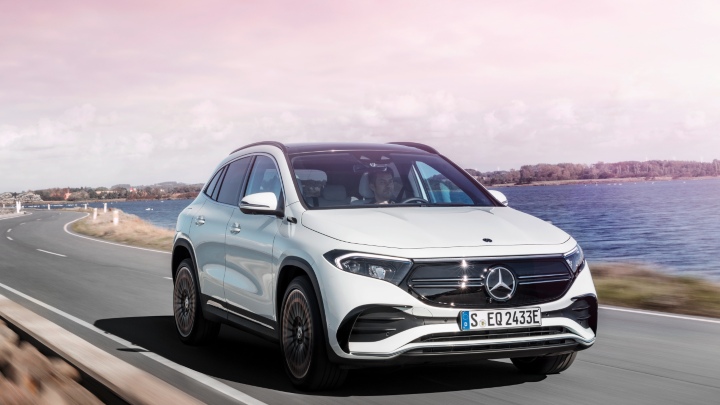 White Mercedes-Benz EQA driving on coastal road