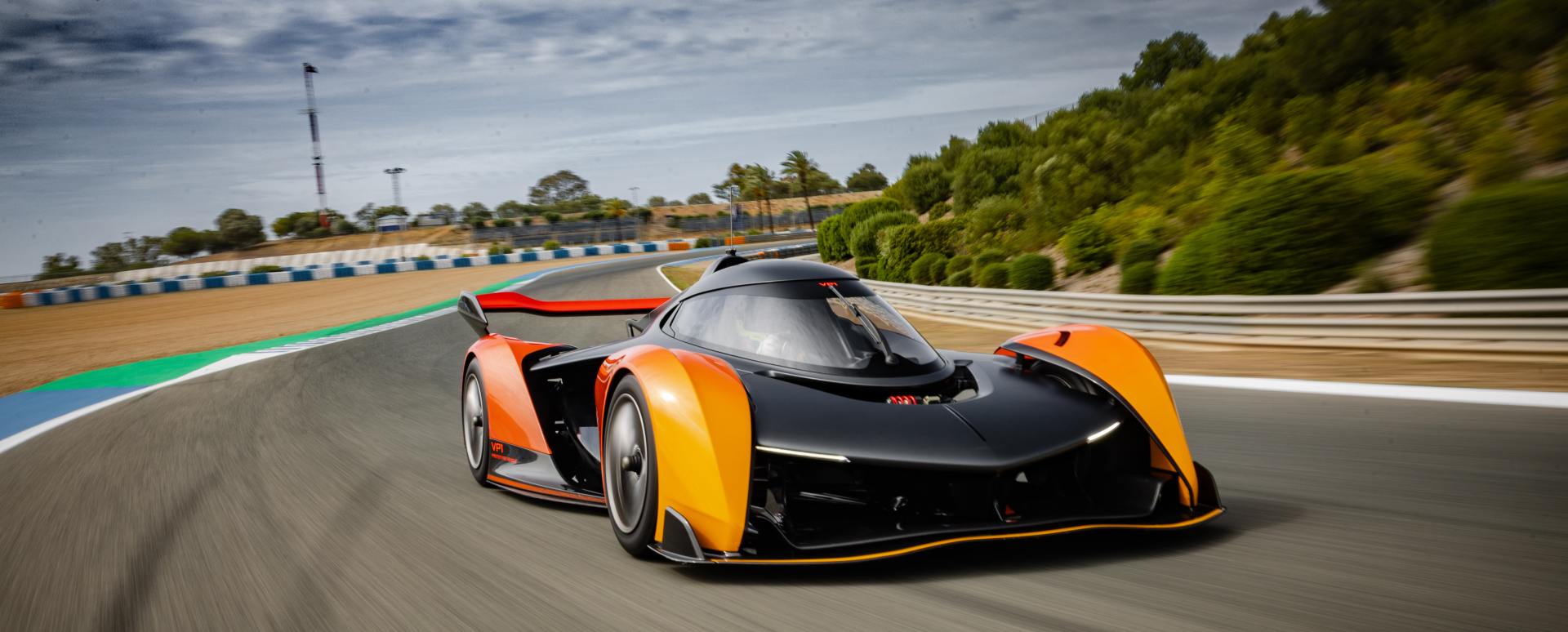 McLaren Solus GT driving at speed on a race track, showcasing aerodynamic design and performance