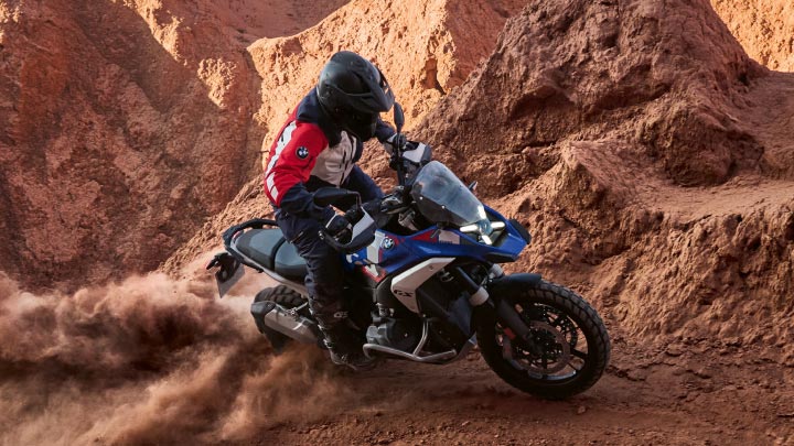 Motorcyclist Riding BMW Motorrad Approved Used Bike Through Rocky Terrain