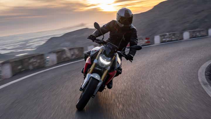 Motorcyclist Riding BMW F 900 R On Mountain Road