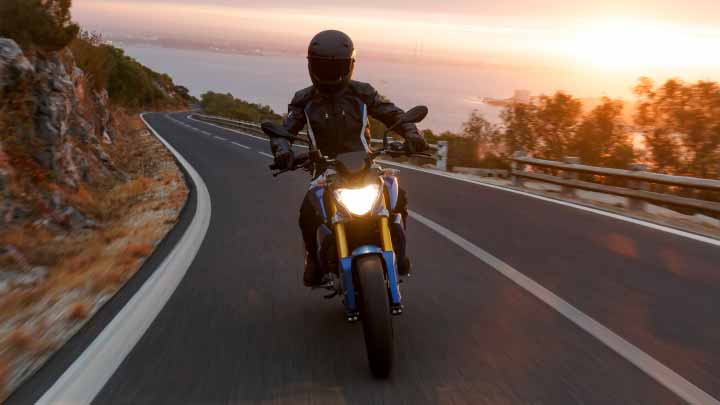Motorcyclist Riding BMW G 310 R On Mountain Road
