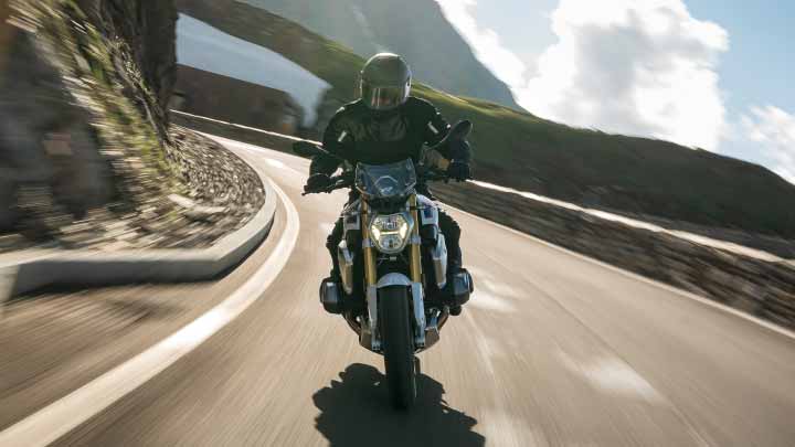 Motorcyclist Riding BMW R 1250 R On Mountain Road