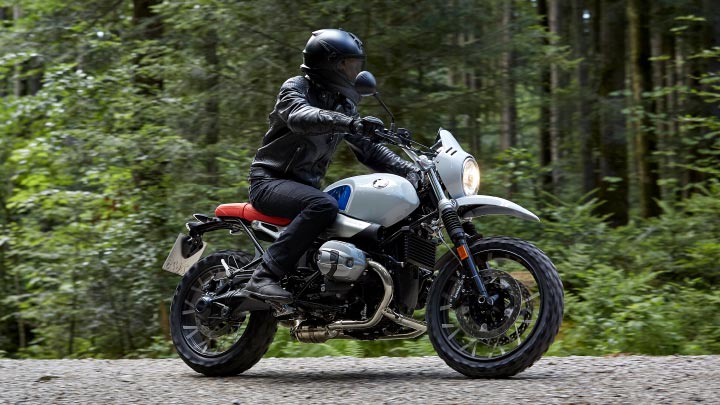Motorcyclist Riding BMW R NineT Urban GS Forest Road