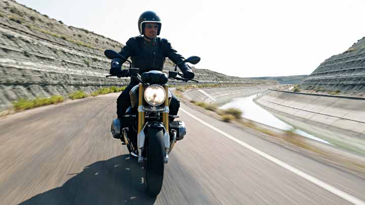 Motorcyclist Riding BMW R NineT On Road