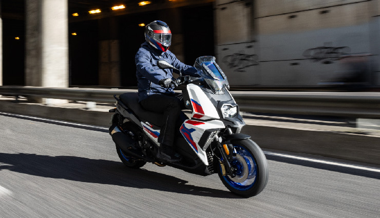 Motorcyclist Riding BMW Motorrad C 400 X Through Town