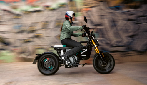 Motorcyclist Riding BMW Motorrad CE 02 Through Town