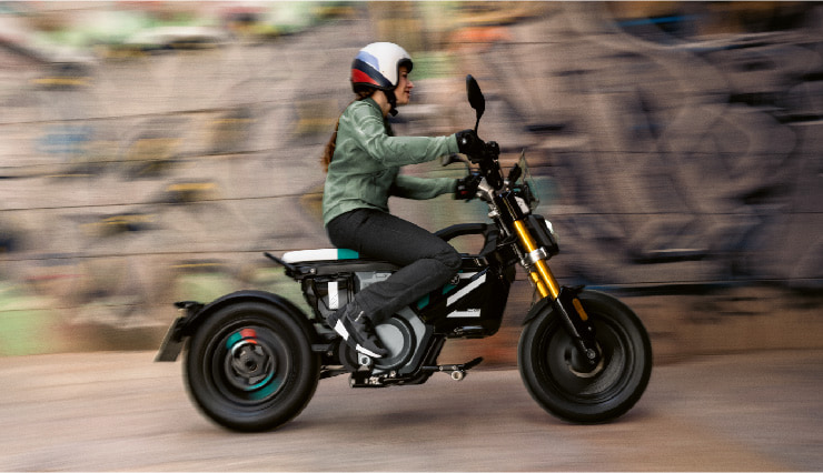 Motorcyclist Riding BMW Motorrad CE 02 Through Town