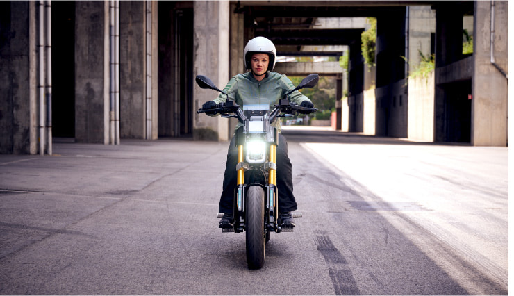 Motorcyclist Riding BMW Motorrad CE 02 Through Town