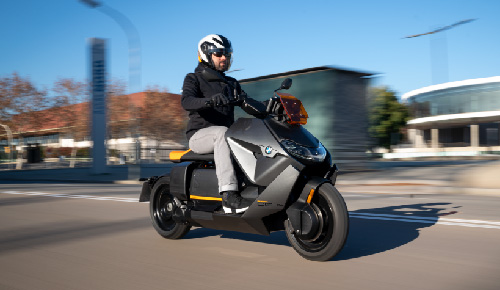 Motorcyclist Riding BMW Motorrad CE 04 Through Town
