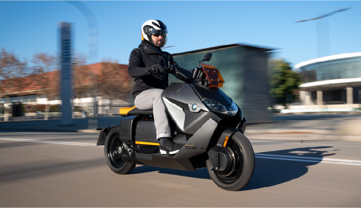 Motorcyclist Riding BMW Motorrad CE 04 Through Town