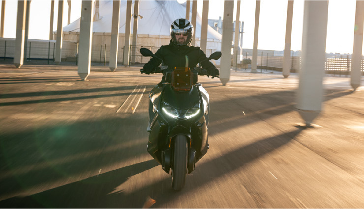 Motorcyclist Riding BMW Motorrad CE 04 Through Town