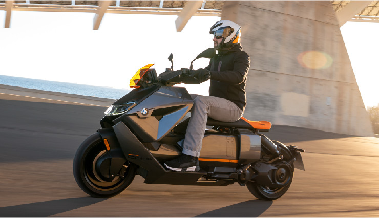 Motorcyclist Riding BMW Motorrad CE 04 Through Town