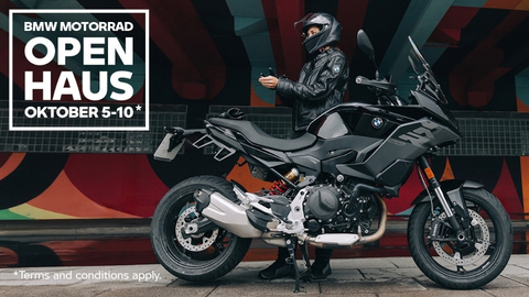 2 People On BMW Motorbikes On A Road