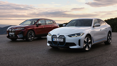 BMW iX parked next to a white BMW i4