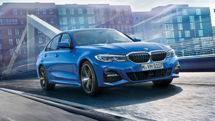 BMW 3 Series in blue on the road.