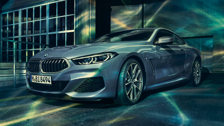 BMW 8 Series Coupe in blue parked.