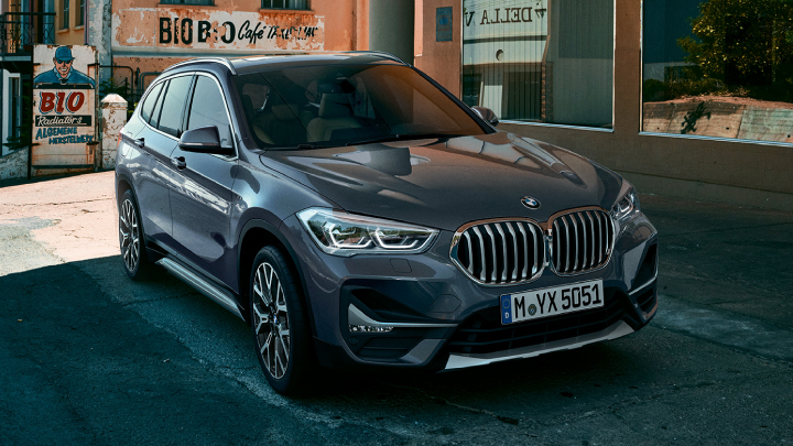 BMW X1 in grey parked on the road.