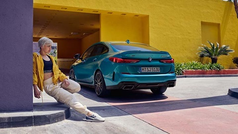 bmw 2 series lifestyle shot with yellow buildings in background