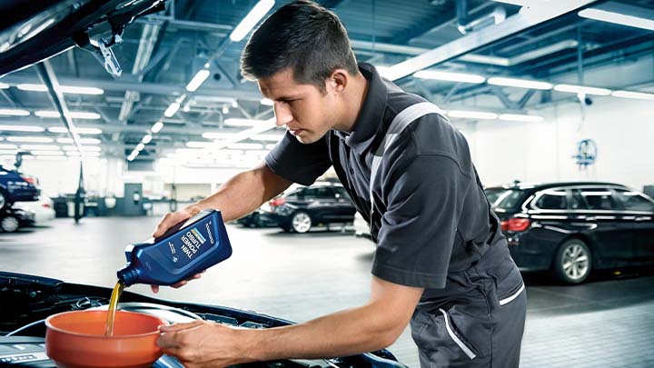 bmw technician replacing engine oil