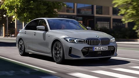 Lifestyle shot of a grey BMW 3 Series saloon driving