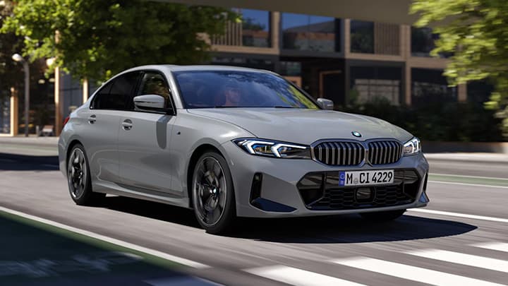 Lifestyle shot of a grey BMW 3 Series saloon driving