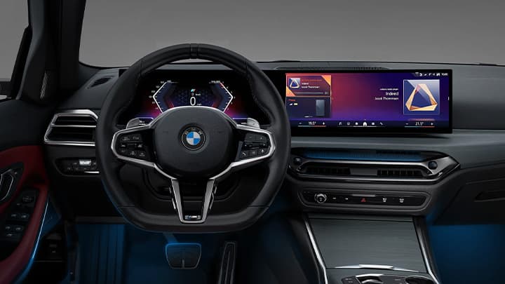 Interior shot of a BMW 3 Series steering wheel and iDrive system