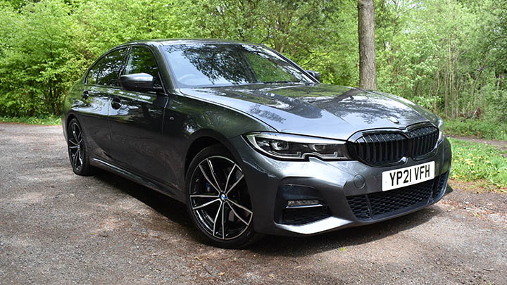 Grey BMW 3 Series, parked in woodland