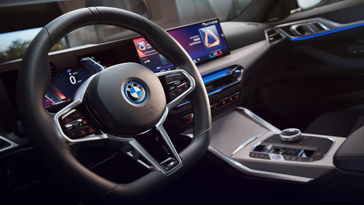 Close up of a BMW i4's steering wheel and infotainment display